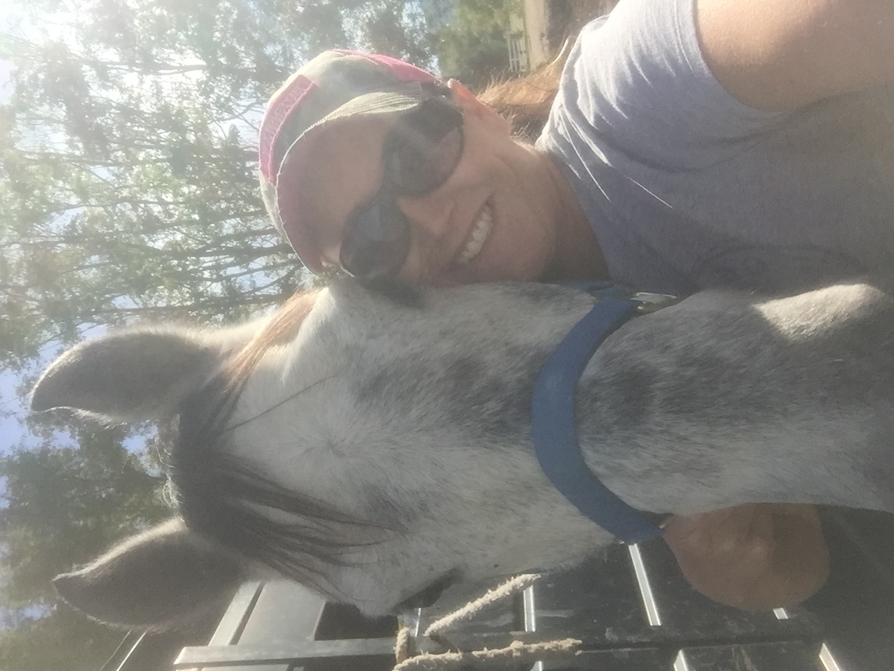 Chelise sharing a close moment with a gray horse